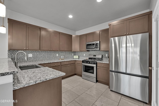 203 Bretby Pl, El Paso, TX 79928 - kitchen featuring appliances with stainless steel finishes, tasteful backsplash, light stone countertops, recessed lighting, and decorative light fixtures