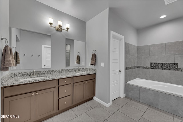 203 Bretby Pl, El Paso, TX 79928 - bathroom featuring a relaxing tiled tub, double vanity, and tile patterned floors