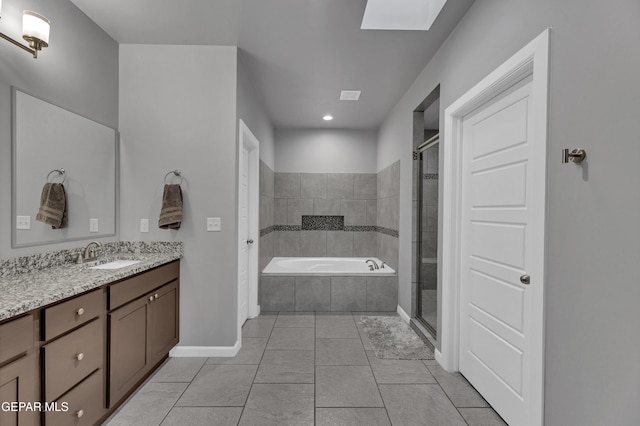 203 Bretby Pl, El Paso, TX 79928 - full bath featuring vanity, a garden tub, a skylight, a stall shower, and tile patterned flooring