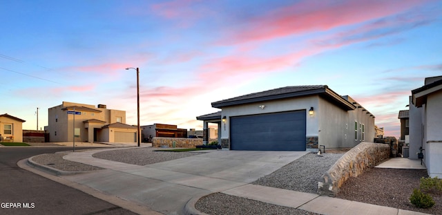 203 Bretby Pl, El Paso, TX 79928 - view of front of house with a garage, concrete driveway, stucco siding, and stone siding