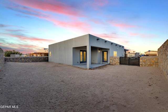 203 Bretby Pl, El Paso, TX 79928 - back of property at dusk featuring a patio and french doors