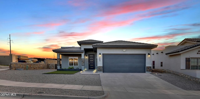 203 Bretby Pl, El Paso, TX 79928 - view of front of home featuring a garage, driveway, stucco siding, and a tile roof