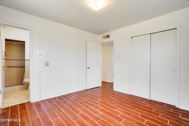 10317 Wilshire Dr, El Paso, TX 79924 - unfurnished bedroom featuring wood finished floors, a closet, and ensuite bathroom