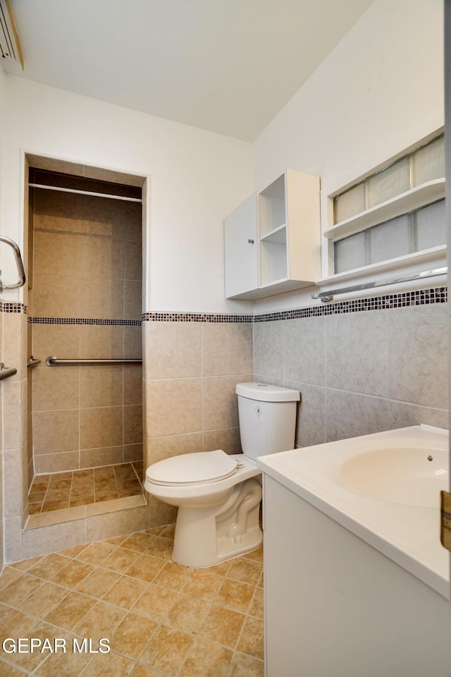 10317 Wilshire Dr, El Paso, TX 79924 - full bathroom featuring tile walls, vanity, a stall shower, tile patterned floors, and an AC wall unit