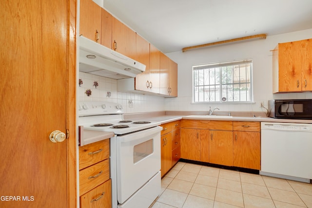 10317 Wilshire Dr, El Paso, TX 79924 - kitchen featuring white appliances, under cabinet range hood, light countertops, backsplash, and light tile patterned floors