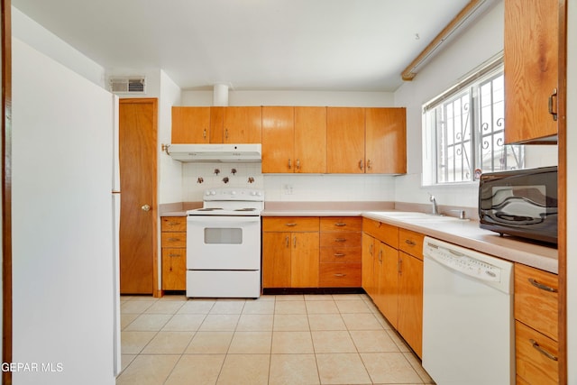 10317 Wilshire Dr, El Paso, TX 79924 - kitchen featuring white appliances, under cabinet range hood, tasteful backsplash, and light countertops