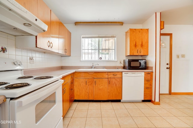 10317 Wilshire Dr, El Paso, TX 79924 - kitchen with white appliances, under cabinet range hood, decorative backsplash, and light countertops