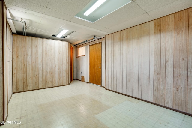 10317 Wilshire Dr, El Paso, TX 79924 - spare room with a drop ceiling, tile patterned floors, and wood walls