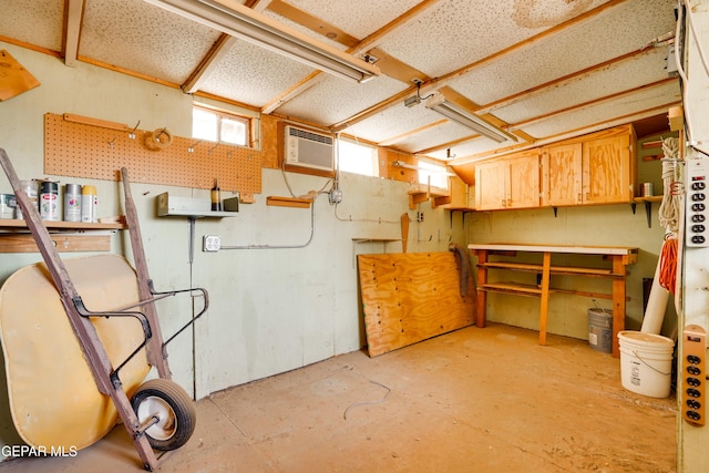 10317 Wilshire Dr, El Paso, TX 79924 - basement with a workshop area and a wall mounted AC