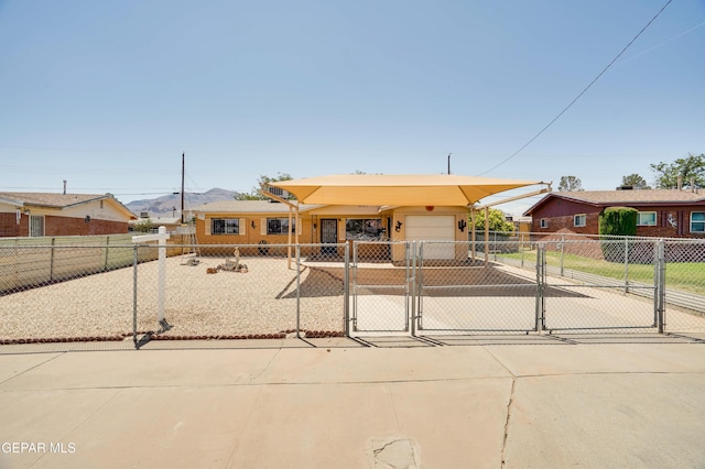 10317 Wilshire Dr, El Paso, TX 79924 - view of front of home featuring driveway, a fenced front yard, a gate, and an attached garage