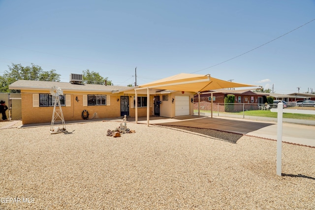 10317 Wilshire Dr, El Paso, TX 79924 - view of front of house featuring an attached garage, brick siding, and driveway