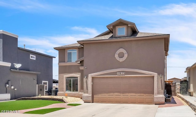 12879 Hidden Grove Dr, El Paso, TX 79938 - view of front of house with driveway, stucco siding, and an attached garage