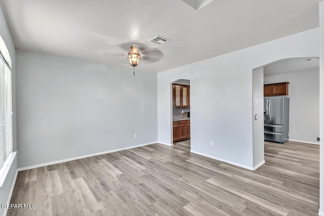 12879 Hidden Grove Dr, El Paso, TX 79938 - unfurnished room featuring arched walkways, a ceiling fan, and light wood finished floors