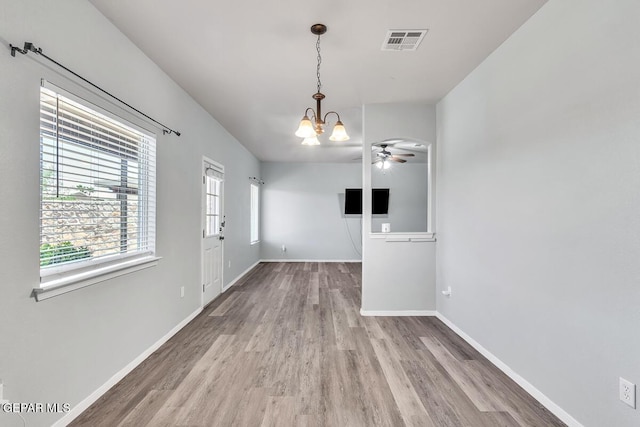 12879 Hidden Grove Dr, El Paso, TX 79938 - unfurnished dining area with wood finished floors, a ceiling fan, and a chandelier