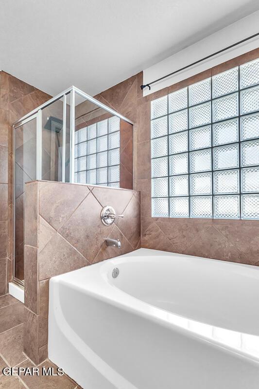 12879 Hidden Grove Dr, El Paso, TX 79938 - full bath with a garden tub, a shower stall, plenty of natural light, and tile patterned flooring