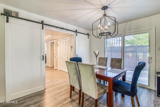 350 Thunderbird Dr Unit 59, El Paso, TX 79912 - dining space featuring a barn door, wood finished floors, and a chandelier
