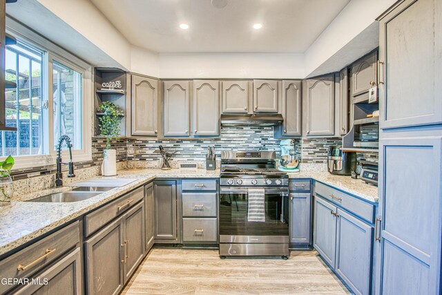 350 Thunderbird Dr Unit 59, El Paso, TX 79912 - kitchen with gas stove, under cabinet range hood, open shelves, decorative backsplash, and light stone counters