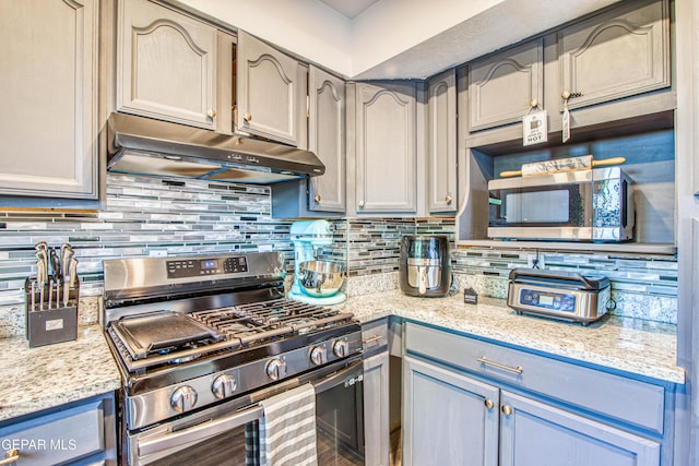 350 Thunderbird Dr Unit 59, El Paso, TX 79912 - kitchen featuring stainless steel appliances, under cabinet range hood, tasteful backsplash, and light stone counters