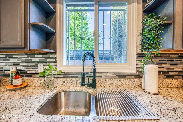 350 Thunderbird Dr Unit 59, El Paso, TX 79912 - kitchen featuring healthy amount of natural light, decorative backsplash, and light stone countertops