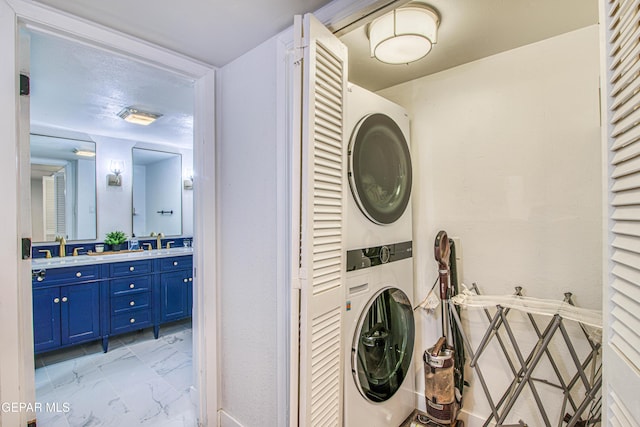 350 Thunderbird Dr Unit 59, El Paso, TX 79912 - laundry room featuring stacked washing machine and dryer and light marble finish flooring