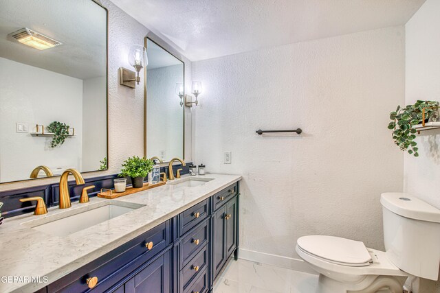 350 Thunderbird Dr Unit 59, El Paso, TX 79912 - bathroom with marble look tile flooring, double vanity, and a textured wall