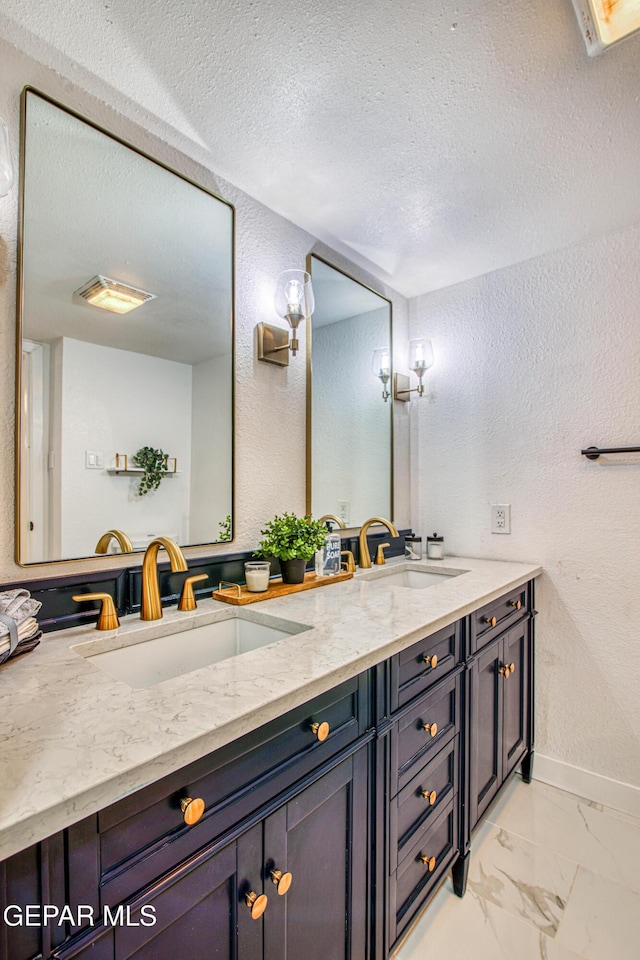 350 Thunderbird Dr Unit 59, El Paso, TX 79912 - bathroom with a textured wall, double vanity, marble look tiles, and a textured ceiling
