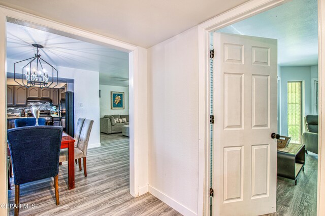 350 Thunderbird Dr Unit 59, El Paso, TX 79912 - hall with light wood-style floors and a chandelier