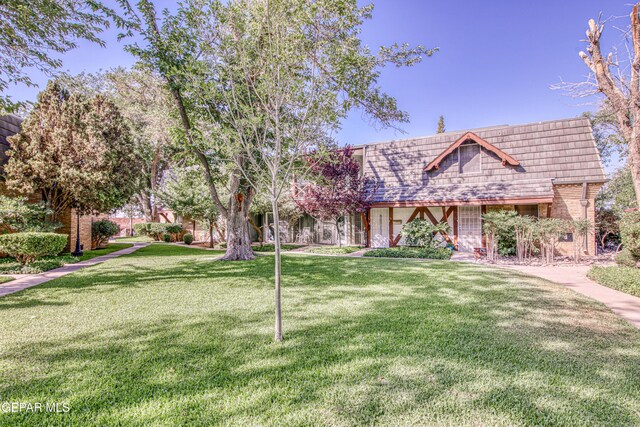 350 Thunderbird Dr Unit 59, El Paso, TX 79912 - tudor-style house featuring a front lawn and brick siding