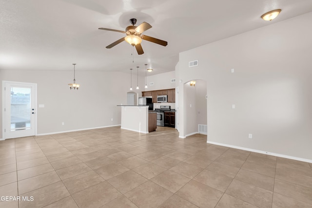 14197 Ranier Point Dr, El Paso, TX 79938 - unfurnished living room featuring a ceiling fan, light tile patterned floors, lofted ceiling, and arched walkways