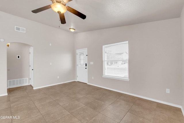 14197 Ranier Point Dr, El Paso, TX 79938 - unfurnished room with arched walkways, light tile patterned flooring, and ceiling fan