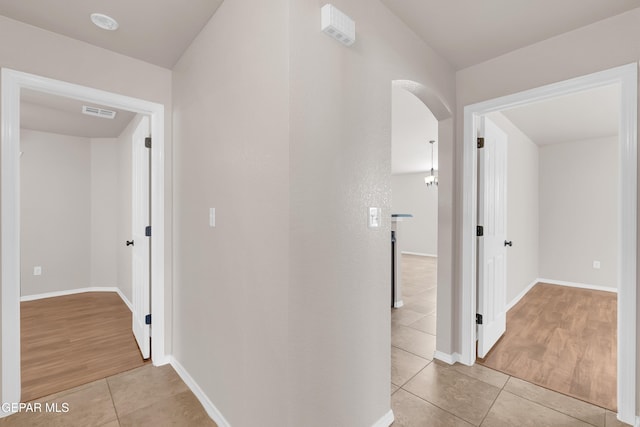 14197 Ranier Point Dr, El Paso, TX 79938 - hall with light tile patterned floors and arched walkways