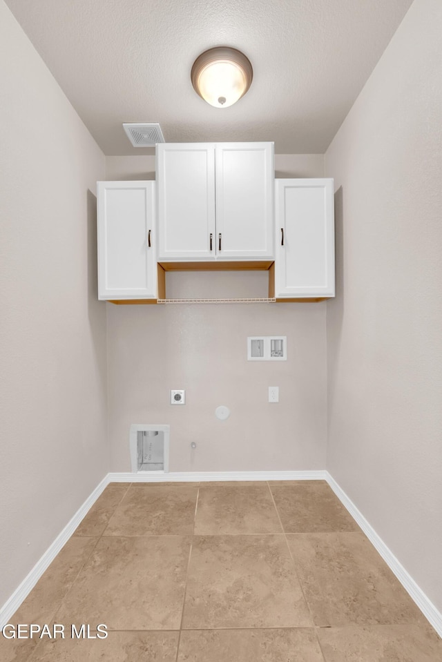 14197 Ranier Point Dr, El Paso, TX 79938 - laundry area featuring hookup for a gas dryer, cabinet space, hookup for an electric dryer, hookup for a washing machine, and a textured ceiling