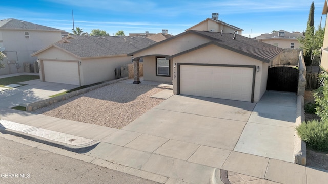 14197 Ranier Point Dr, El Paso, TX 79938 - ranch-style house featuring an attached garage, driveway, and stucco siding