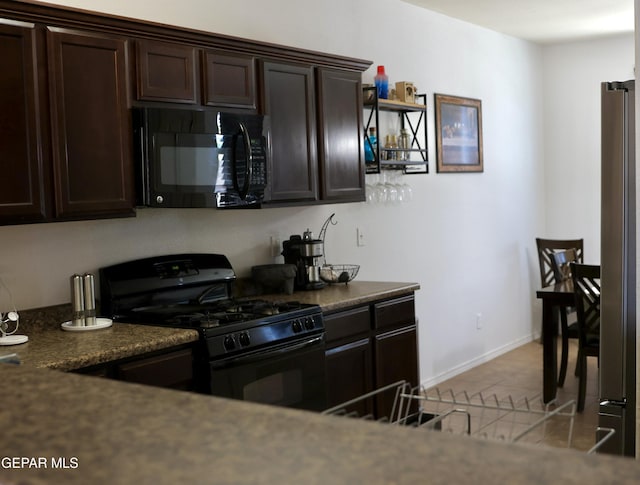 14251 Rattler Point Dr, El Paso, TX 79938 - kitchen with black appliances, dark countertops, dark brown cabinets, and light tile patterned floors