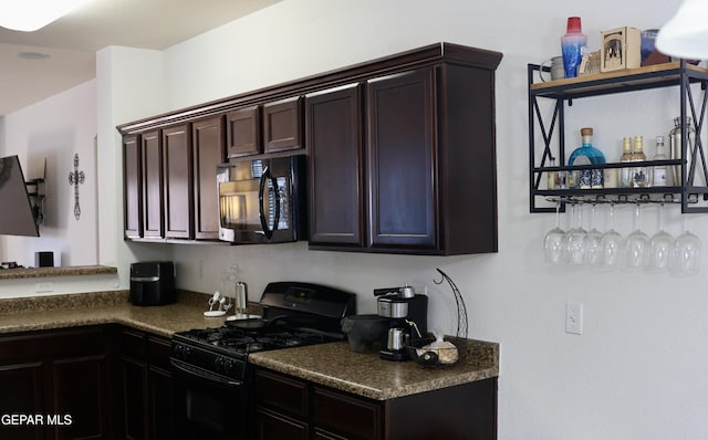 14251 Rattler Point Dr, El Paso, TX 79938 - kitchen with black appliances, dark countertops, and dark brown cabinetry