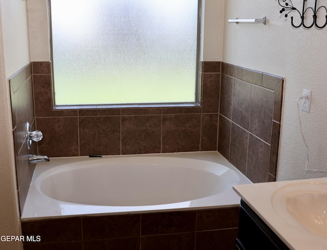 14251 Rattler Point Dr, El Paso, TX 79938 - full bath featuring healthy amount of natural light, a bath, vanity, and a textured wall