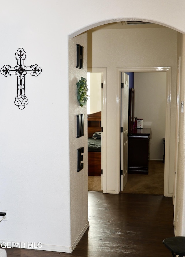 14251 Rattler Point Dr, El Paso, TX 79938 - hallway with arched walkways and dark wood finished floors