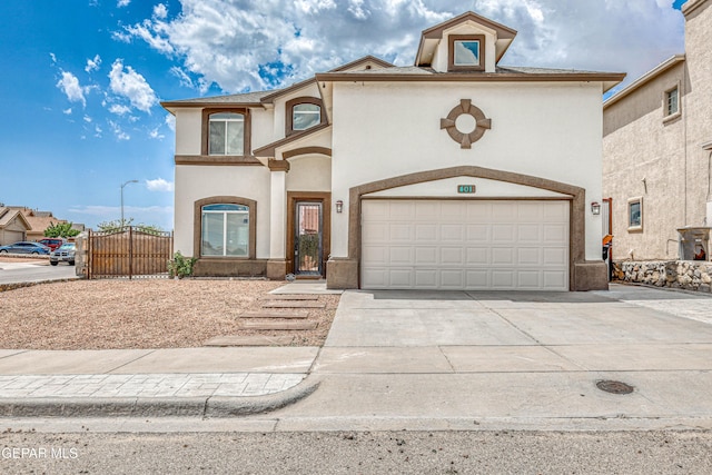 401 Everlook Ln, Horizon City, TX 79928 - mediterranean / spanish home featuring a gate, stucco siding, concrete driveway, and a garage