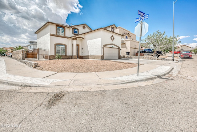 401 Everlook Ln, Horizon City, TX 79928 - mediterranean / spanish home with concrete driveway, stucco siding, an attached garage, and a gate