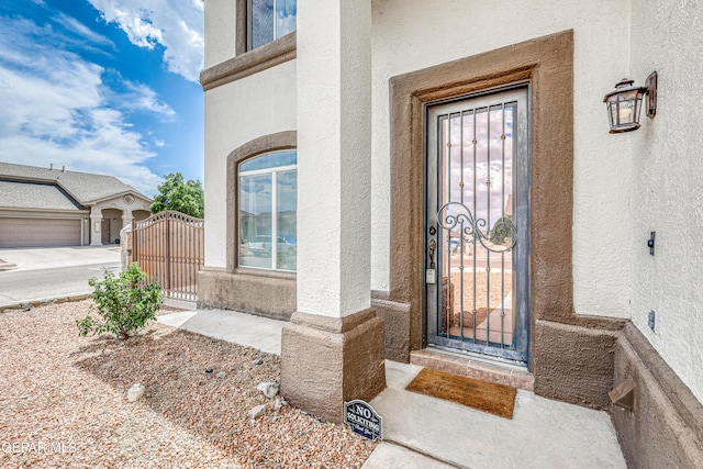 401 Everlook Ln, Horizon City, TX 79928 - doorway to property featuring a gate and stucco siding
