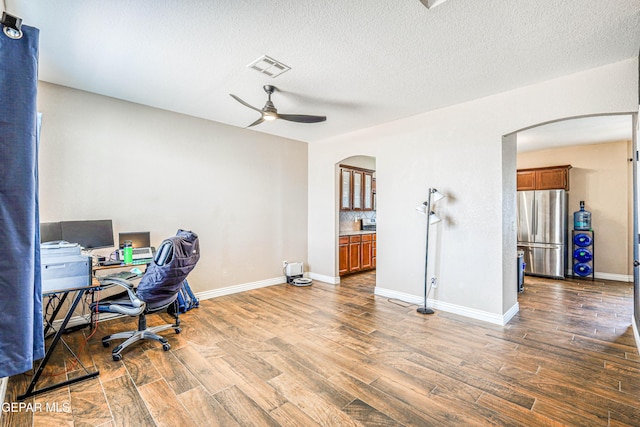 401 Everlook Ln, Horizon City, TX 79928 - office area with arched walkways, ceiling fan, wood finished floors, and a textured ceiling