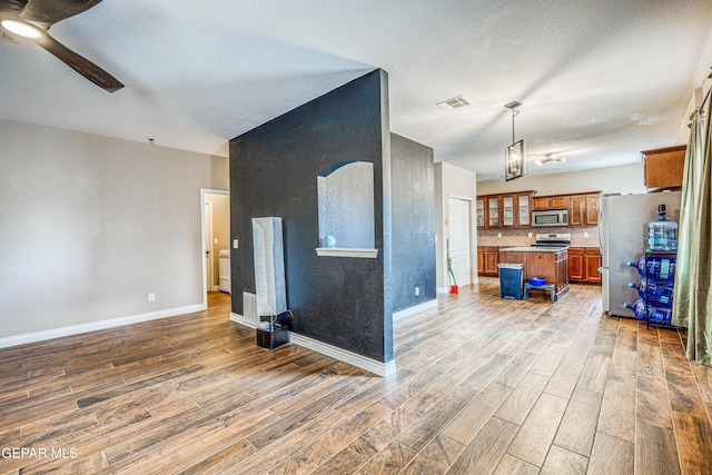 401 Everlook Ln, Horizon City, TX 79928 - living room with wood finished floors, a ceiling fan, and a chandelier