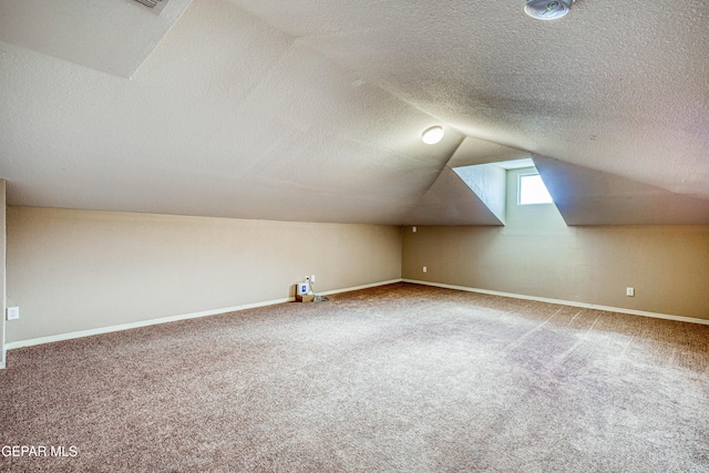 401 Everlook Ln, Horizon City, TX 79928 - bonus room featuring carpet flooring, vaulted ceiling, and a textured ceiling