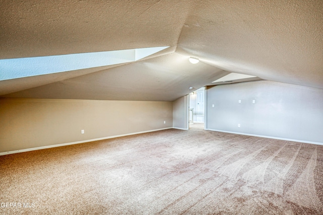 401 Everlook Ln, Horizon City, TX 79928 - additional living space featuring carpet floors, a textured ceiling, and vaulted ceiling