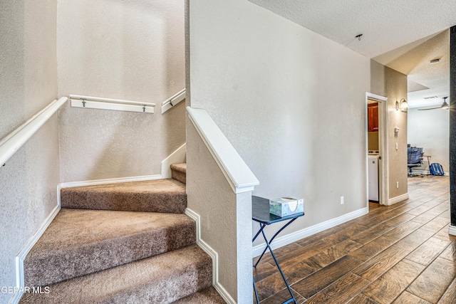 401 Everlook Ln, Horizon City, TX 79928 - stairs featuring wood finished floors, a textured wall, and a ceiling fan