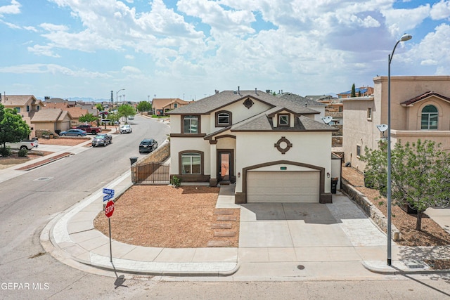 401 Everlook Ln, Horizon City, TX 79928 - view of front of property featuring stucco siding, a gate, driveway, a shingled roof, and a residential view
