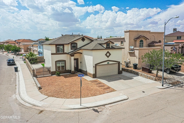 401 Everlook Ln, Horizon City, TX 79928 - view of front facade with stucco siding, a gate, concrete driveway, a residential view, and an attached garage