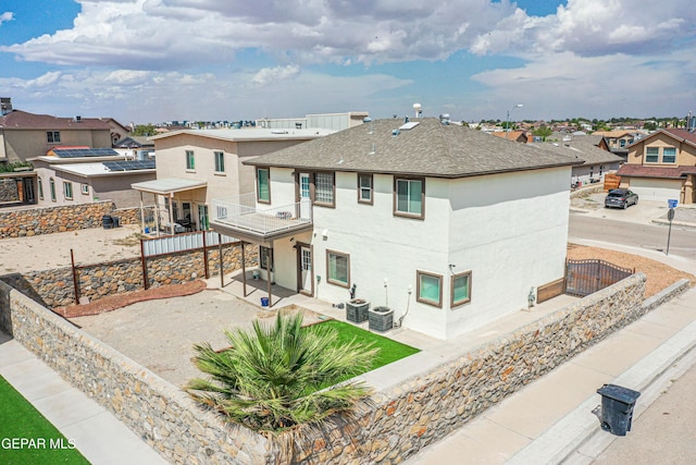 401 Everlook Ln, Horizon City, TX 79928 - view of front facade featuring a balcony, a patio area, a residential view, stucco siding, and roof with shingles