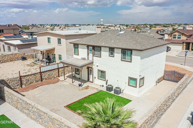 401 Everlook Ln, Horizon City, TX 79928 - back of house featuring a balcony, a residential view, a shingled roof, and a patio