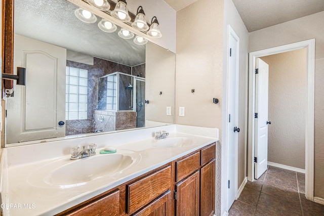 401 Everlook Ln, Horizon City, TX 79928 - bathroom with a shower stall, double vanity, and tile patterned flooring
